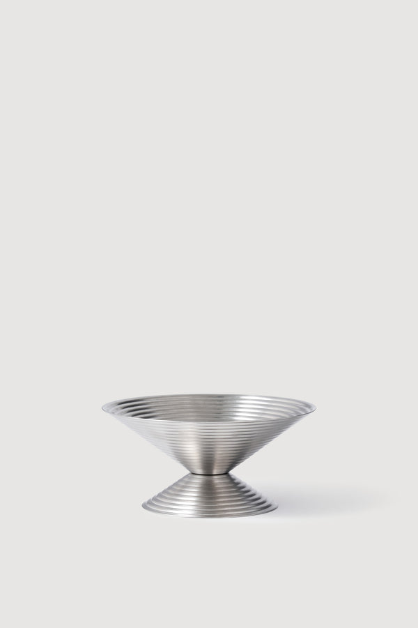 Small stainless steel ice cream cup with a geometric shape, against a plain white background.