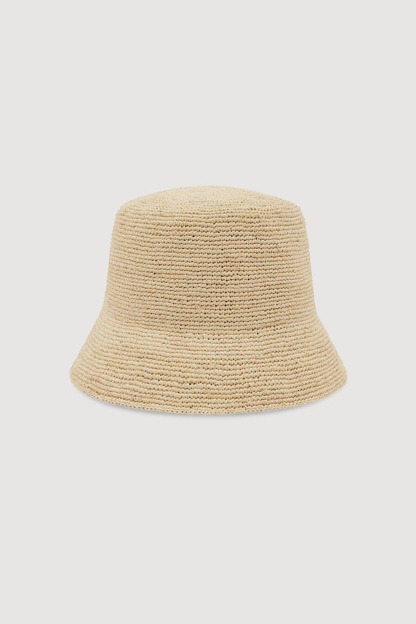 A light beige woven straw bucket hat, shown against a white background.